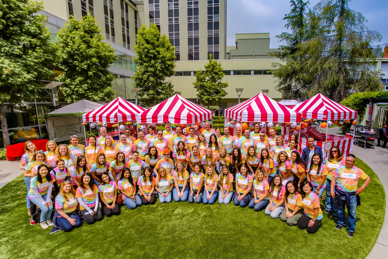 Employees pose together at a company philanthropic event at CHLA